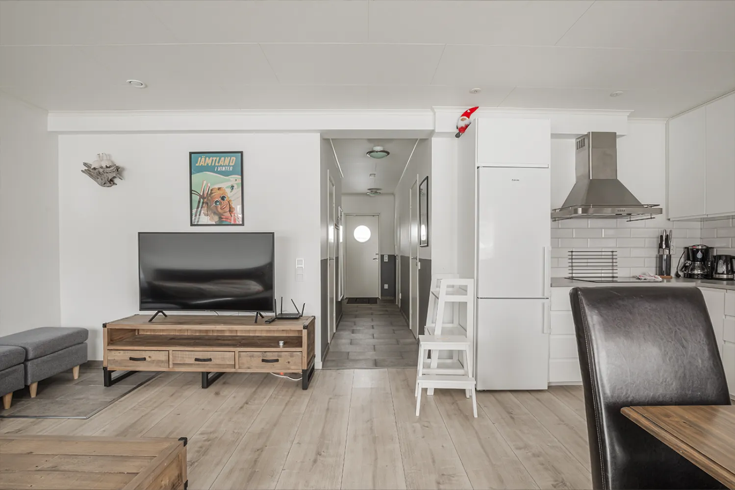 ett vardagsrum med TV och kylskåp