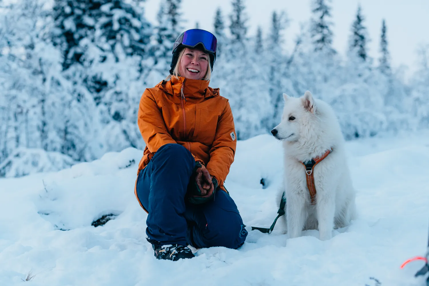 En tjej med en hund i snölandskap