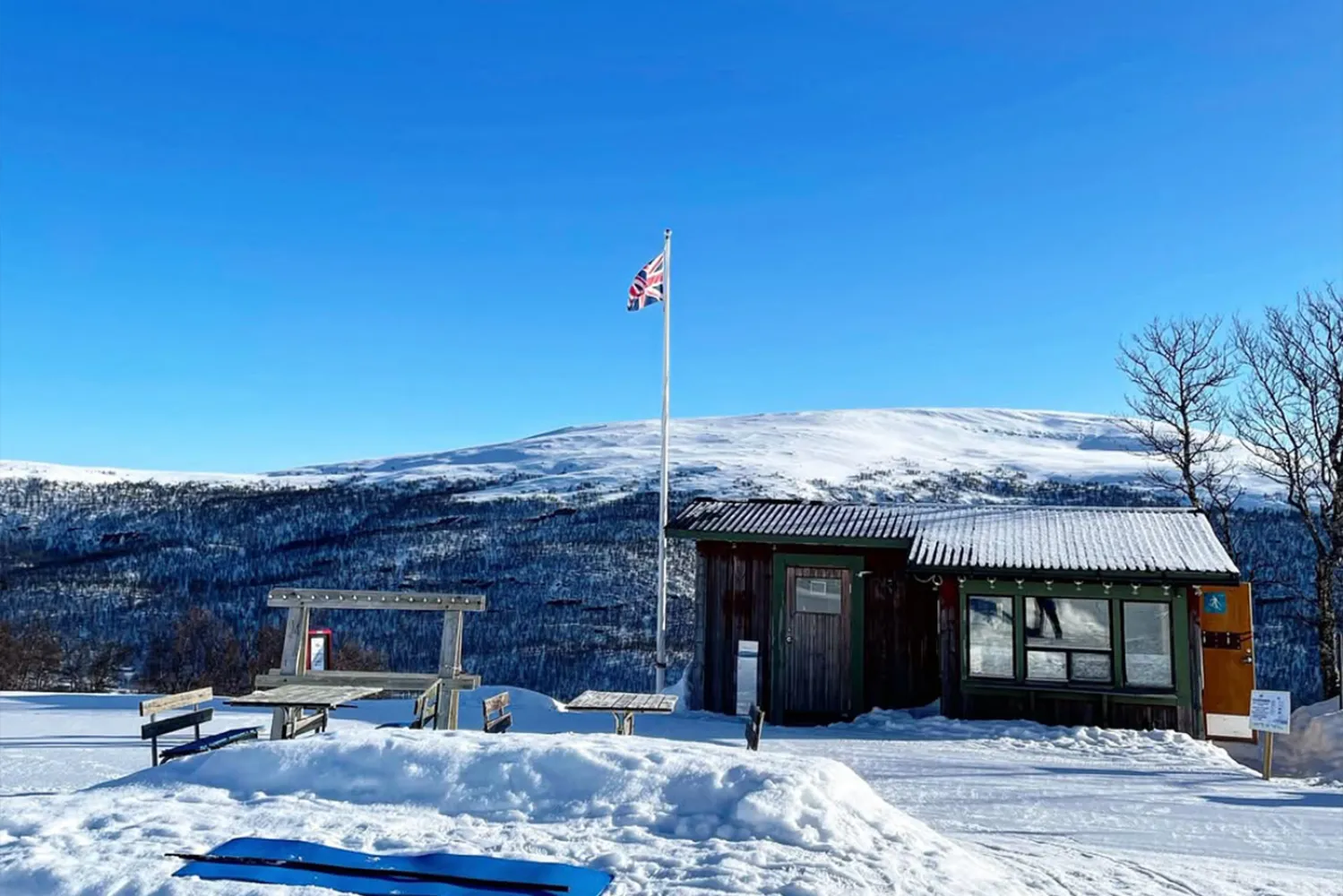 en byggnad med en flagga på en stång i snön